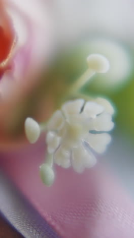 gentle flowers and silk ribbons on table macro view. wedding celebration design trends and ideas. bud with pink petals in bridal ornate composition
