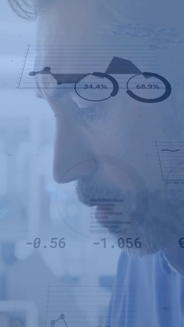 Vertical video: Analyst typing on laptop and driving charts overlaying face while analyzing finance