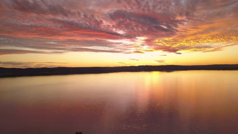 Flying-over-the-beautiful-seaside-of-Long-Jetty-wharf-in-Sydney-during-sunset---aerial