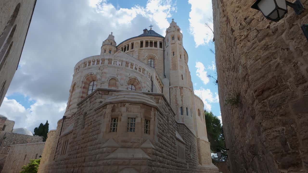 Dormition Abbey in Jerusalem, Israel, seen from a narrow street. Slow motion.