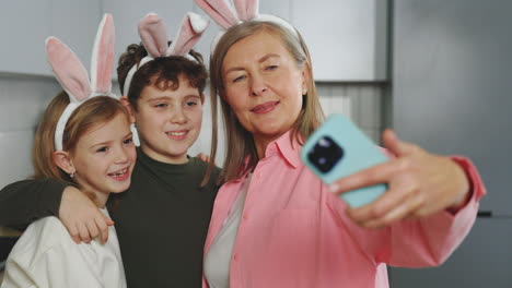 grandparent taking a selfie with grandchildren