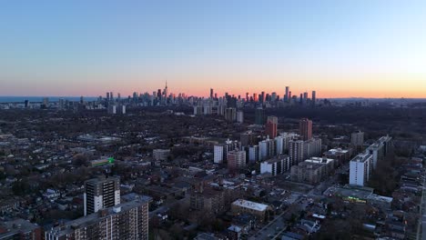 this 4k drone video shows the drone flying over an east york neighbourhood toward downtown toronto at sunset