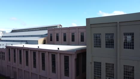 Panning-from-skyline-to-rooftop-and-building-view-of-abandoned,-disused,-derelict-Art-Deco-Power-Station-Warehouse-Factory-in-East-Perth