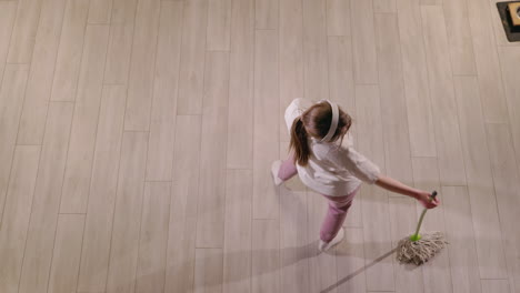 girl dancing while mopping