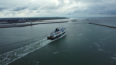 ferry in a harbor under cloudy sky