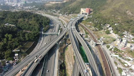 traffic on a massive highway interchange with multiple levels and loop shaped road in hong kong, aerial view