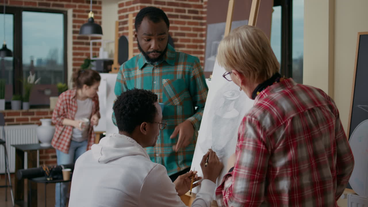 Diverse team of artists drawing vase sketch on canvas