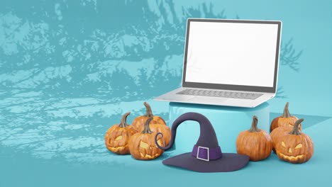 calabazas talladas para halloween con computadora portátil con pantalla blanca en blanco