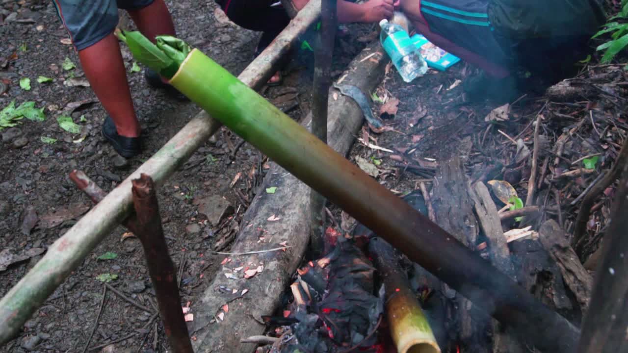 Bamboo shoot buried in the charcoal to cook the food inside of it