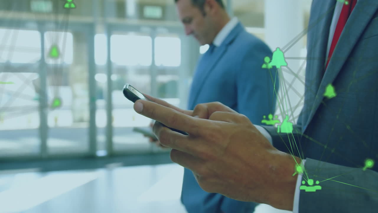 Animation of communication networks over biracial businessman using smartphone in office foyer