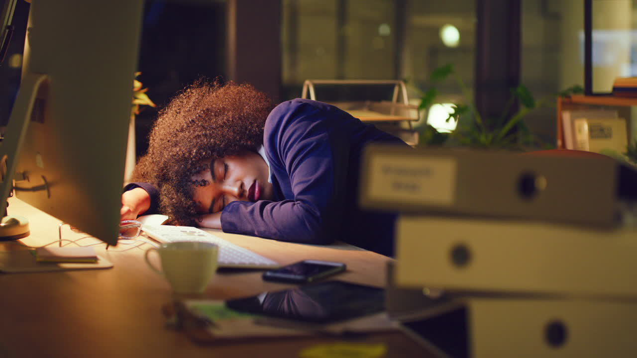 Tired female accounting manager sleeping at a desk