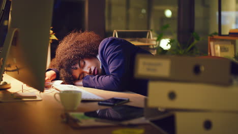 tired female accounting manager sleeping at a desk