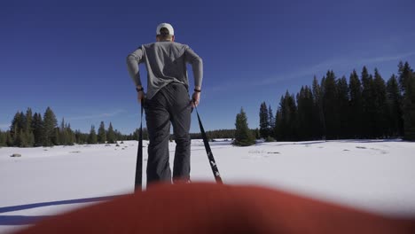 pov snow sled man pulling through nature