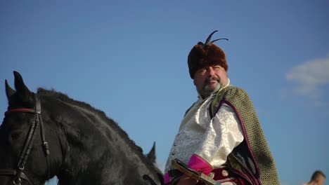 ukrainian ataman riding a horse in the field looks far