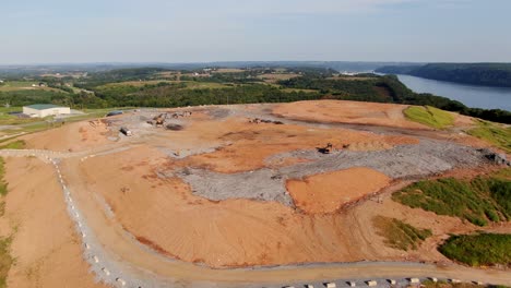 Descending-aerial-reveals-landfill-with-mountains-of-refuse,-unoccupied-equipment-in-Pennsylvania