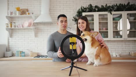 couple with corgi dog shoots video for blog in kitchen