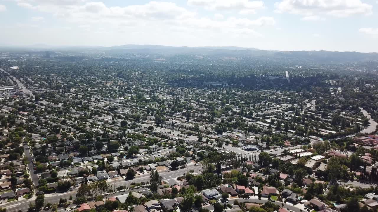 Drone panorama of Luxury city in near Los Angeles. Sunny day with trees along street in Hidden Hills, USA. Wide shot.