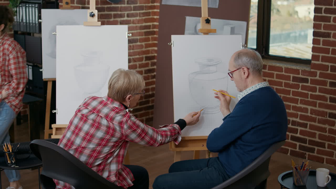 Senior man and woman at community centre drawing vase model