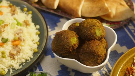 arabian cuisine. bulgur with eggplant, falafel, bean soup on table, couscous with chicken. traditional middle eastern culture. moutabal and vegetable salad in bowls, pita. delicious rice with meat