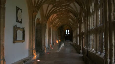 the quiet, atmospheric, arched cloisters in the beautiful medieval cathedral of wells, in england's smallest city