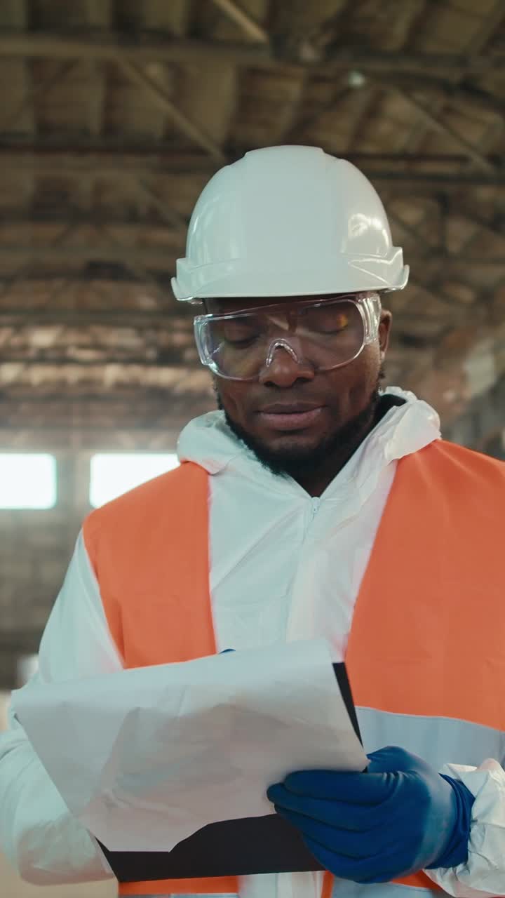 Construction worker inspecting documents