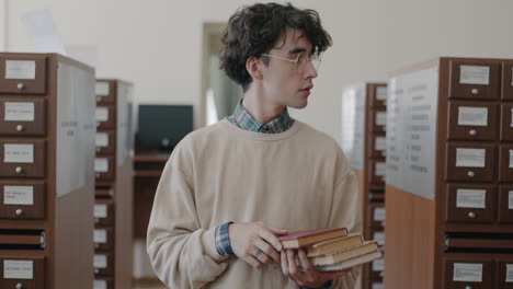 young man in a library with books