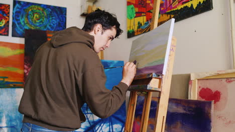 The-Young-Artist-With-A-Smile-On-His-Face-Paints-A-Picture-In-The-Studio