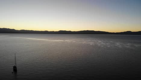 Drone-shot-flying-over-boats-parked-in-a-lake