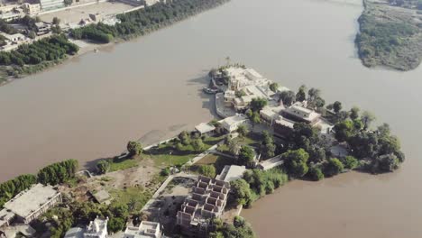 aerial over sadh belo island temple on the indus river, pakistan