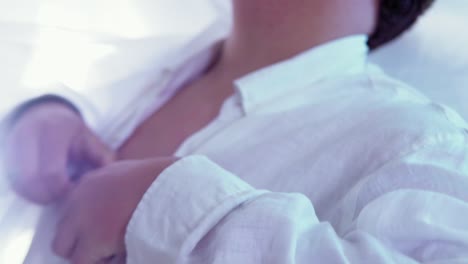 closeup-shot-of-a-lgtb-man-taking-off-the-buttons-of-his-shirt,-with-long-black-nails-and-in-slow-motion