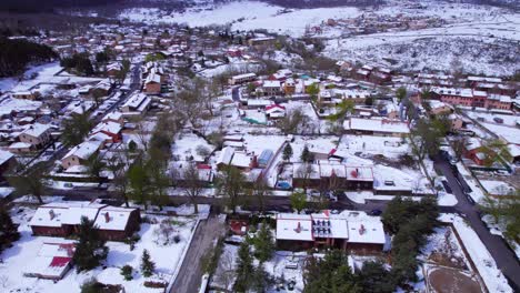 Cinematic-tilt-up-aerial-over-the-town-of-Pradera-de-Navalhorno-in-Spain-on-a-cold-but-sunny-winter's-day