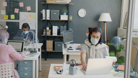 employees working in a modern office with social distancing