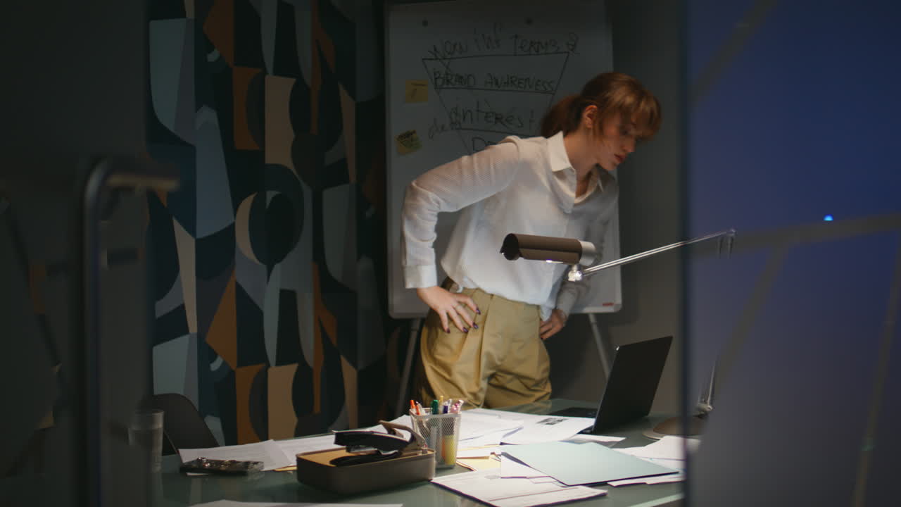 Lady boss staying late at office. Businesswoman turning off light ending work