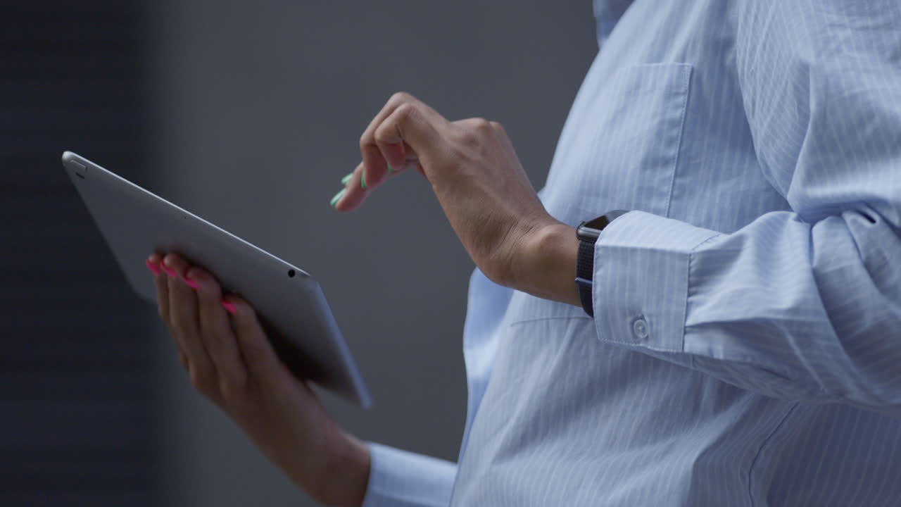 Female hands touching pad screen outdoors closeup. Businesswoman work remotely.