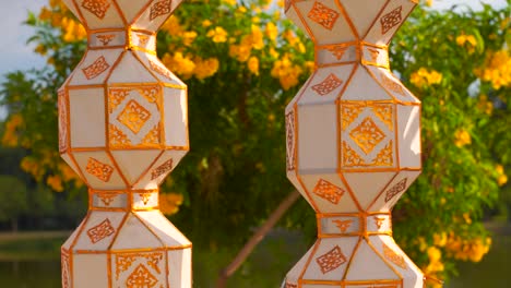 richly decorated paper lanterns softly waving in wind in nature