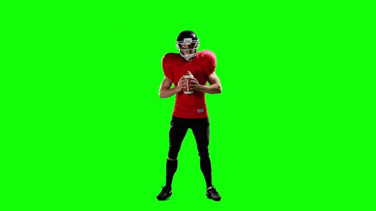 American football player holding ball