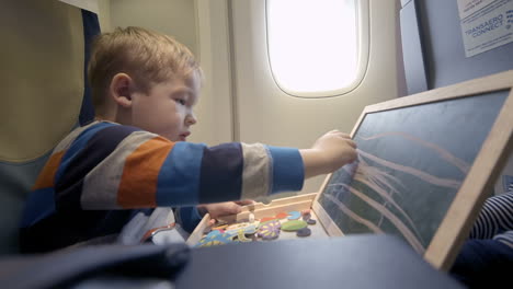 Niño-En-El-Avión-Dibujando-A-Bordo-Con-Tiza