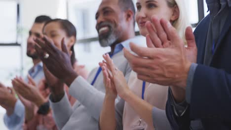 Business-people-applauding-in-conference-room