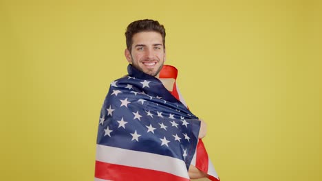 smiling man wrapped in american flag