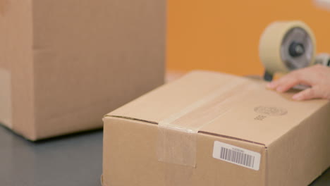 encintado y sellado de una caja de embalaje para el envío.