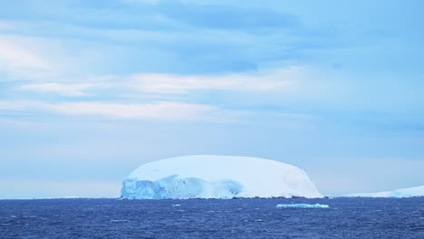 Beautiful-Iceberg-at-Sunset-in-Antarctica,-Big-Large-Massive-Icebergs-with-Amazing-Shape-Ice-Formation,-Sunrise-Seascape-with-Dramatic-Sky-in-Winter-Landscape-Scenery-on-Antarctic-Peninsula