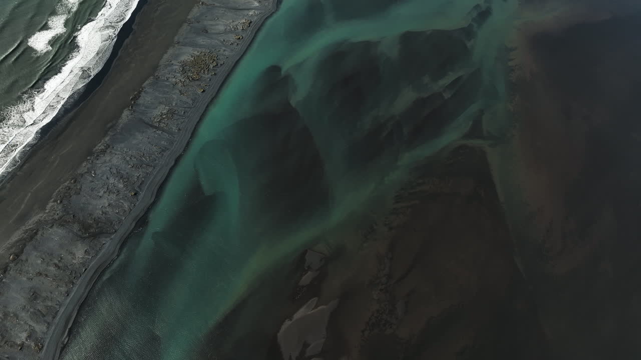 Aerial tilt reveal of the Fjorur beach and the Vestrahorn mountain in Iceland