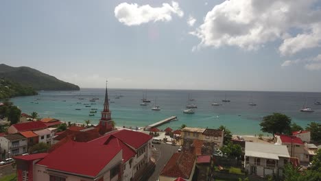 aerial drone shot over a church, pontoon and clear water with boats. beautiful t