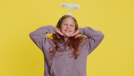 portrait of smiling shy angelic child girl with angel halo nimb over head positive love emotions