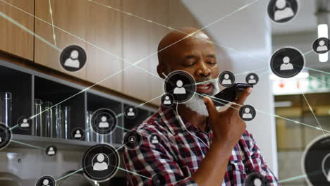 animation of network of connections with icons over businessman using smartphone