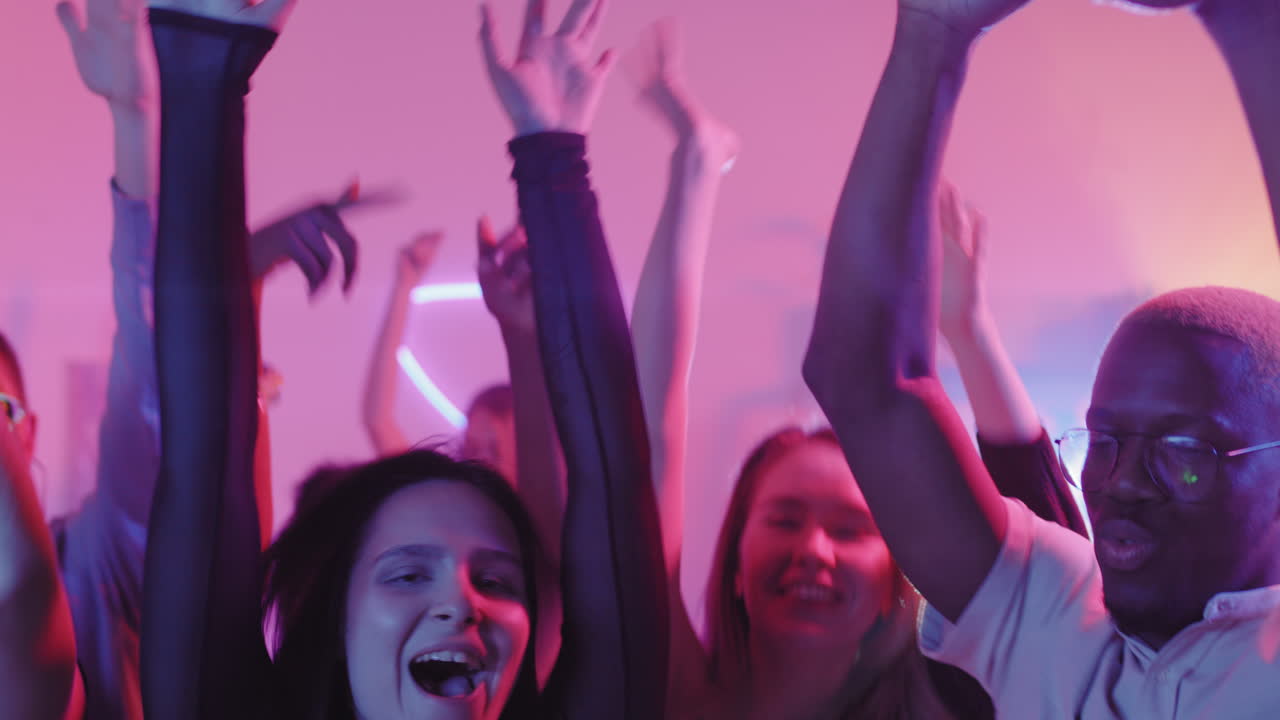 Happy Young People Dancing before Camera