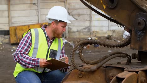 male worker looking at machine 4k