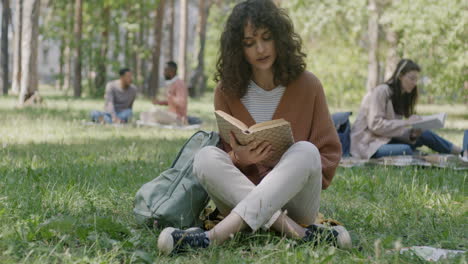 students reading in park