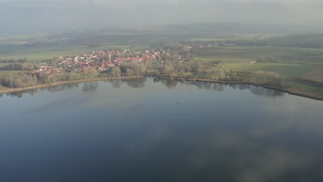 Drone-aerial-of-the-typical-german-village-Seeburg-located-at-the-Seeburger-See-on-a-beautiful-Sunday-morning