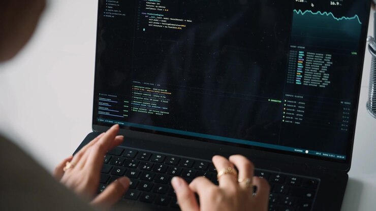 Software Developer Writing Code on Laptop